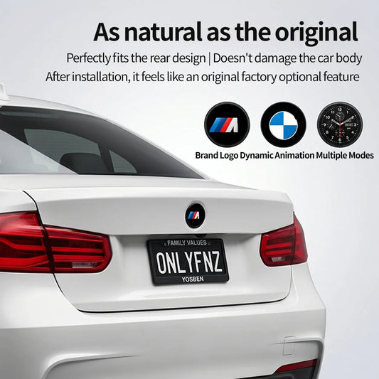 BMW digital display emblem badge installed on the rear of a white BMW 3 Series showing the M logo